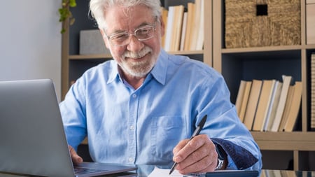 Medicare agent at his desk using a laptop