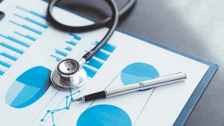 Stethoscope on Medicare report with graphs