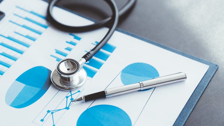 Stethoscope on Medicare report with graphs
