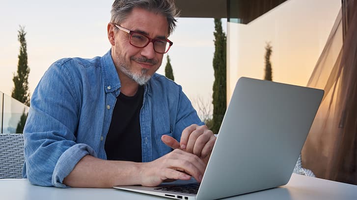 Middle Aged Man Working on Laptop